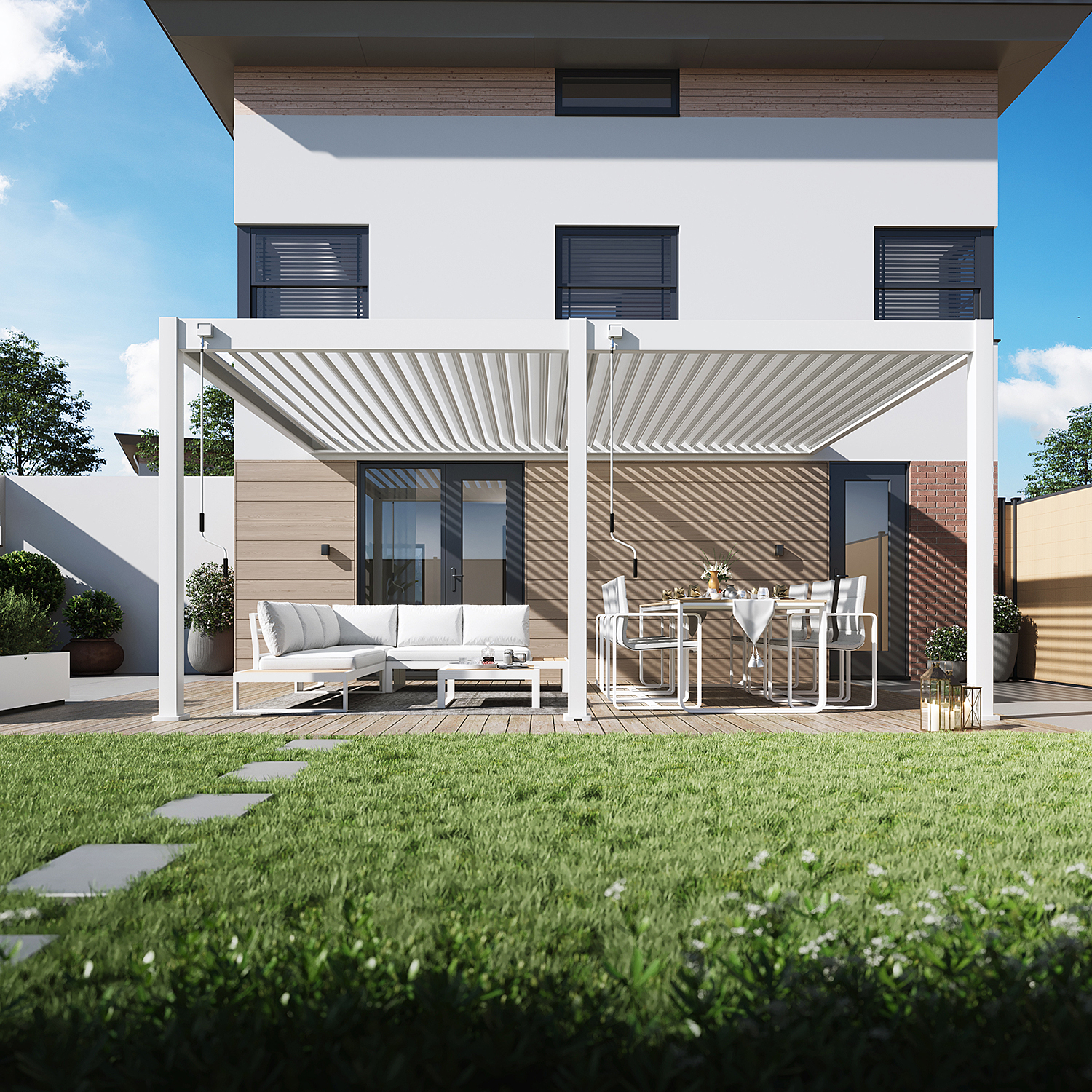 Biela terasová pergola DELUXE Wall 3,6x5,3 Gutroof nad záhradným sedením s rohovou pohovkou a jedálenským stolom pri dome