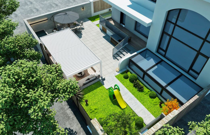 biela bioklimatick&aacute; pergola umiestnen&aacute; v z&aacute;hrade a vyčleňuj&uacute;ca relaxačn&uacute; z&oacute;nu za domom